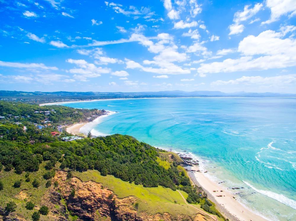 An Aerial View Of A Beach And Ocean On A Sunny Day — Headlands Glass in Byron Bay, NSW