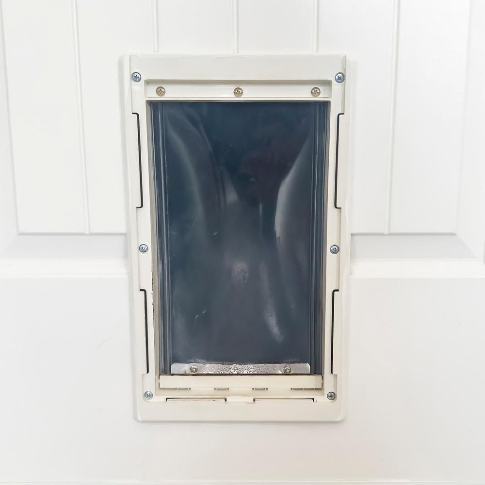 A White Dog Door is Mounted to a White Door — Headlands Glass in Ballina, NSW
