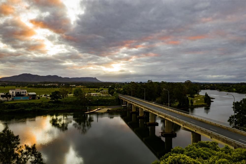 An Aerial View of a Bridge Over a River at Sunset — Headlands Glass in Wollongbar, NSW